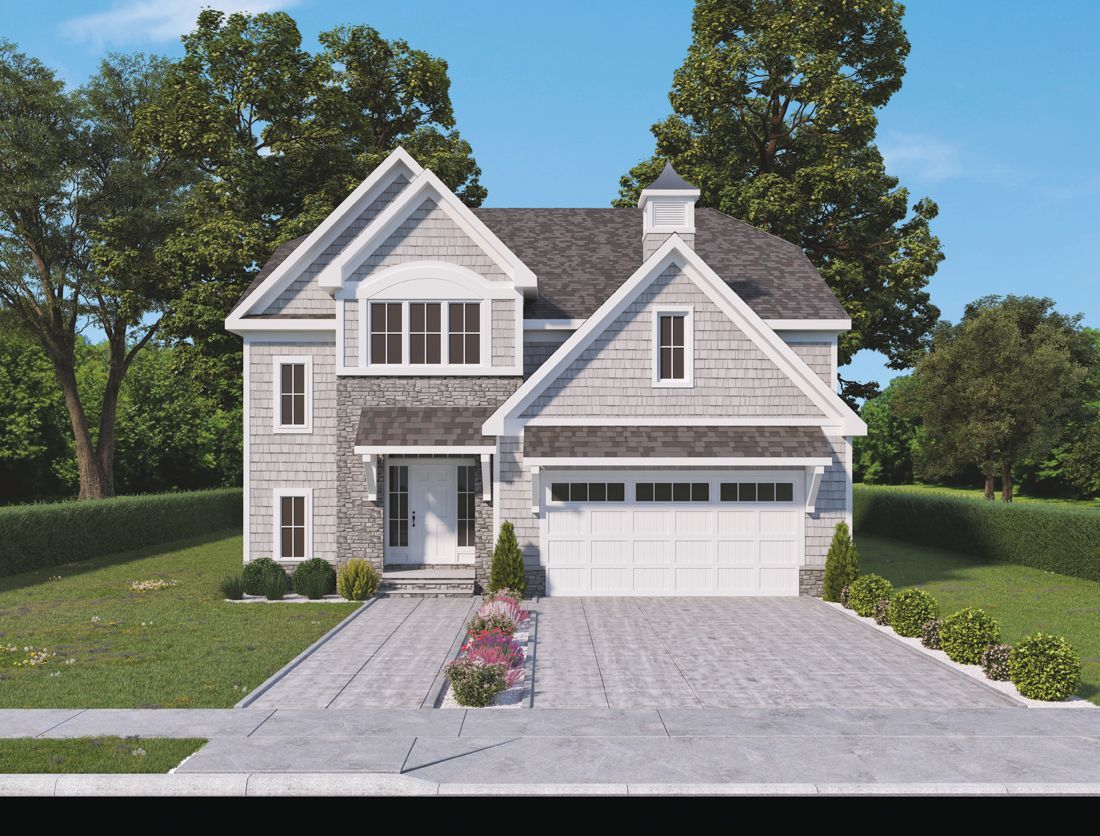 A two-story house with gray siding, stone accents, a white garage door, and a paved driveway in a grassy, suburban setting.