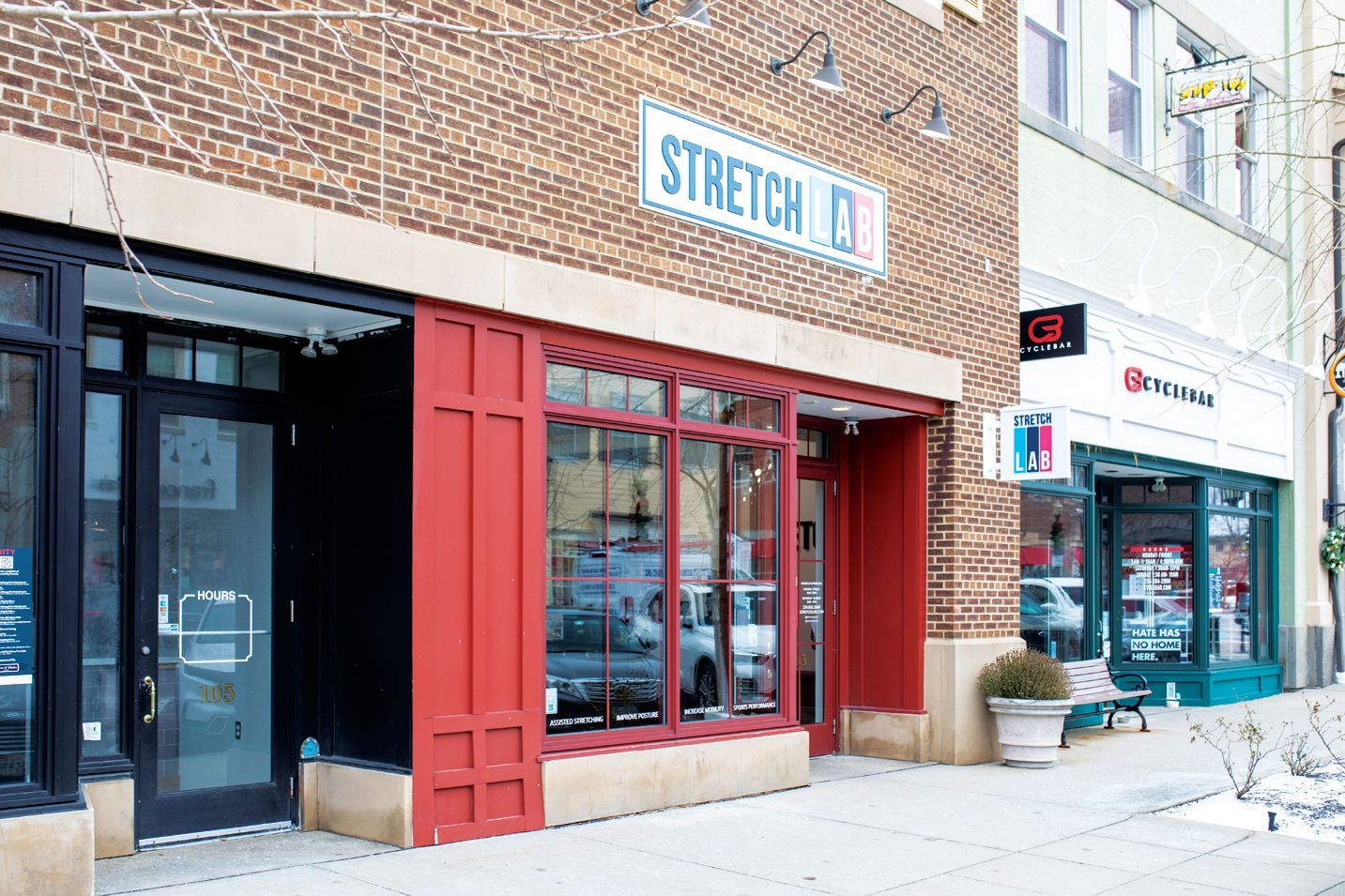 A storefront with a red frame, large windows, and a 