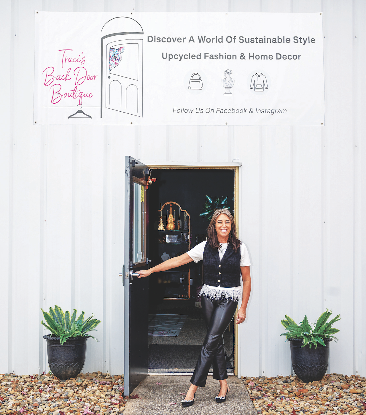 A person smiling while opening the door to a boutique with a banner for sustainable style and recycled fashion.