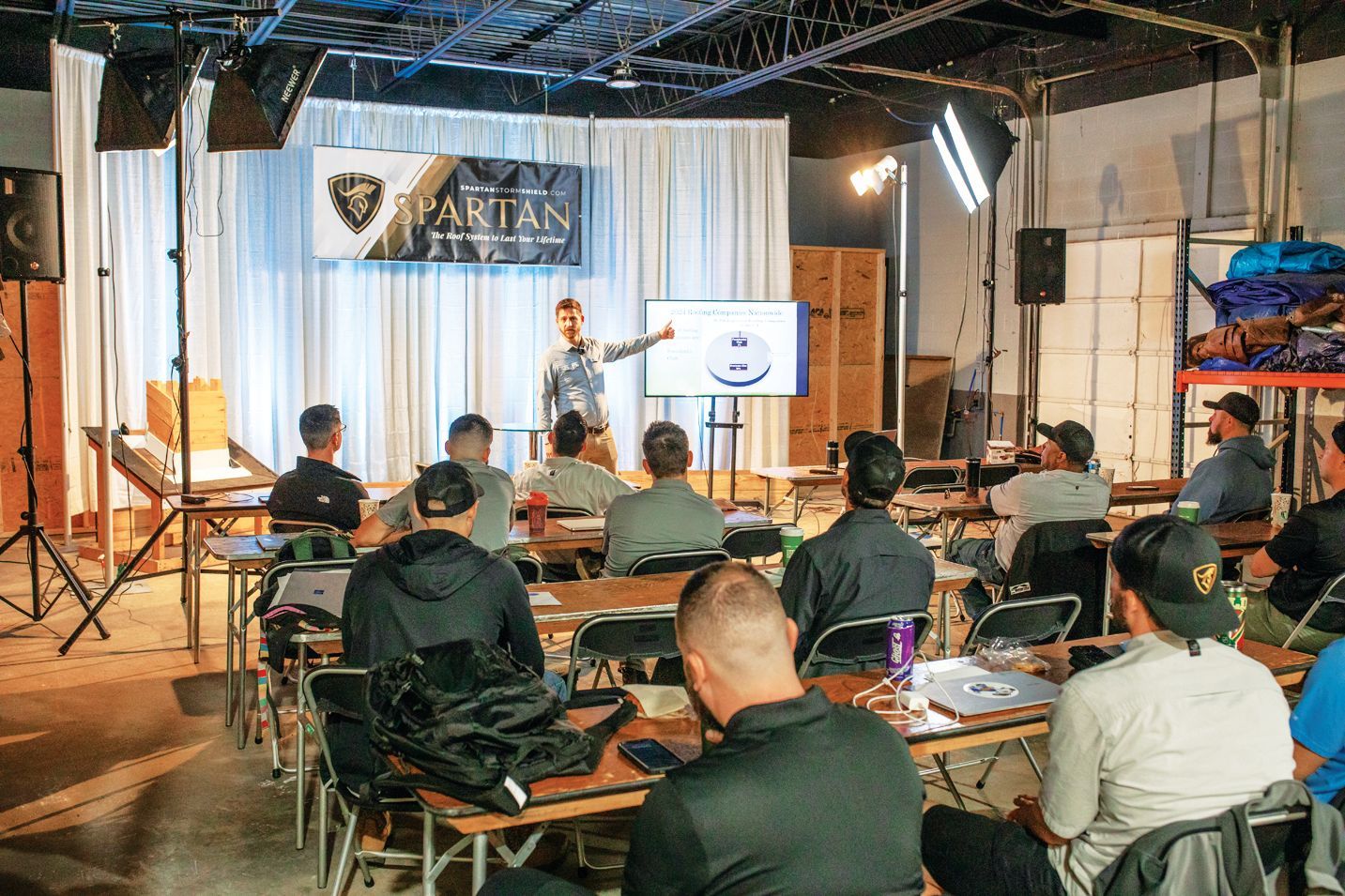 A speaker presents to a small audience in a room with a