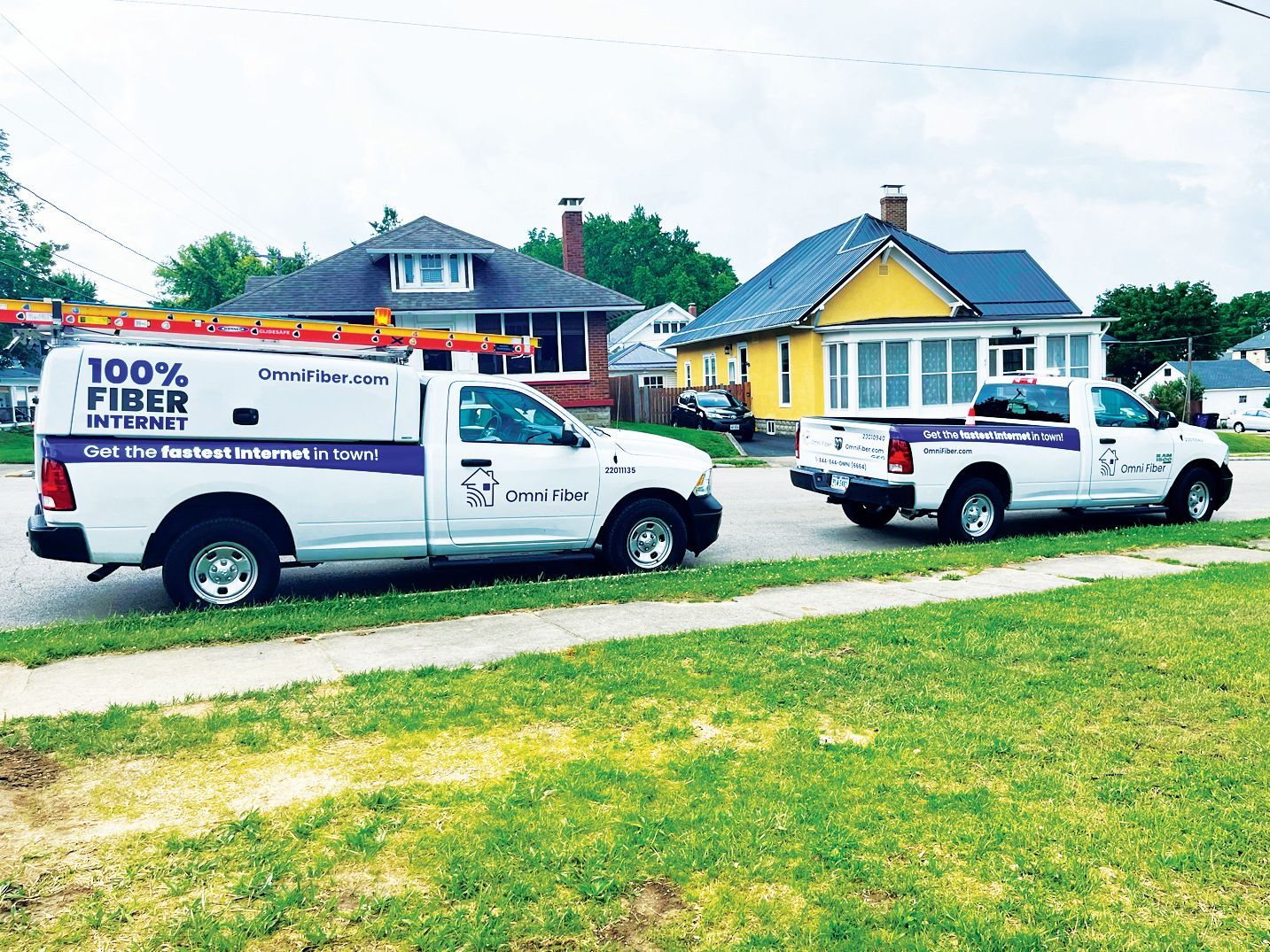 Two white service trucks marked with 