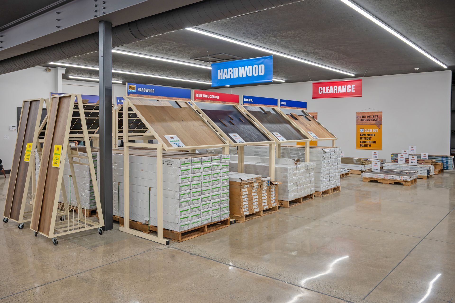 A flooring store display featuring organized stacks of wood planks and tile samples on metal racks under bright lighting.