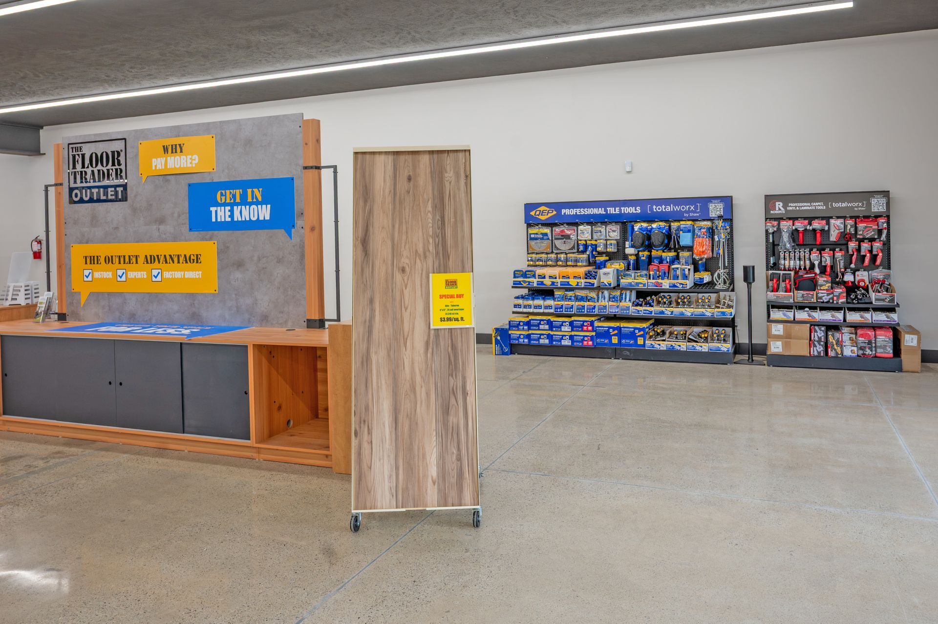 A retail store interior with a wood-look counter, a matching display cabinet, and shelving units filled with merchandise.