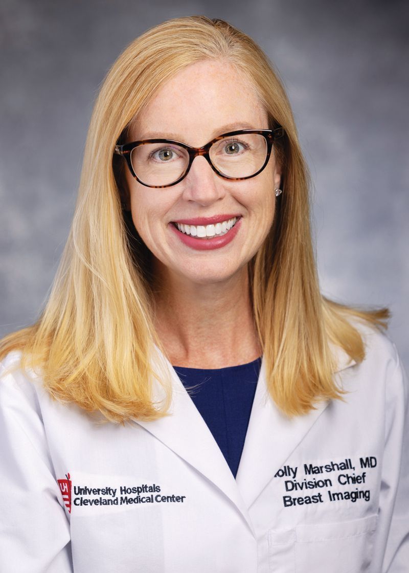 Headshot of Dr. Sally Marshall wearing glasses and a white medical coat with University Hospitals branding.