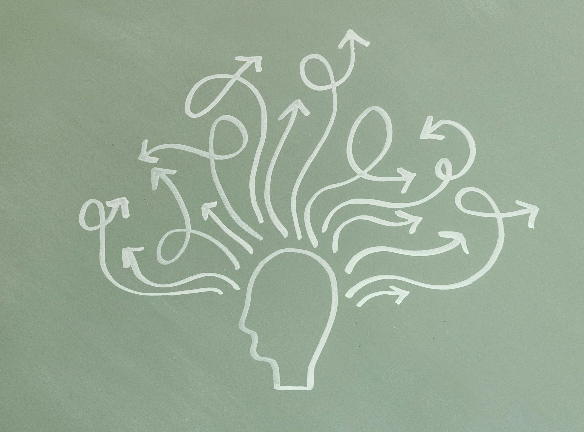 White chalk line drawing of a human head silhouette with many swirling arrows pointing outward from the top.