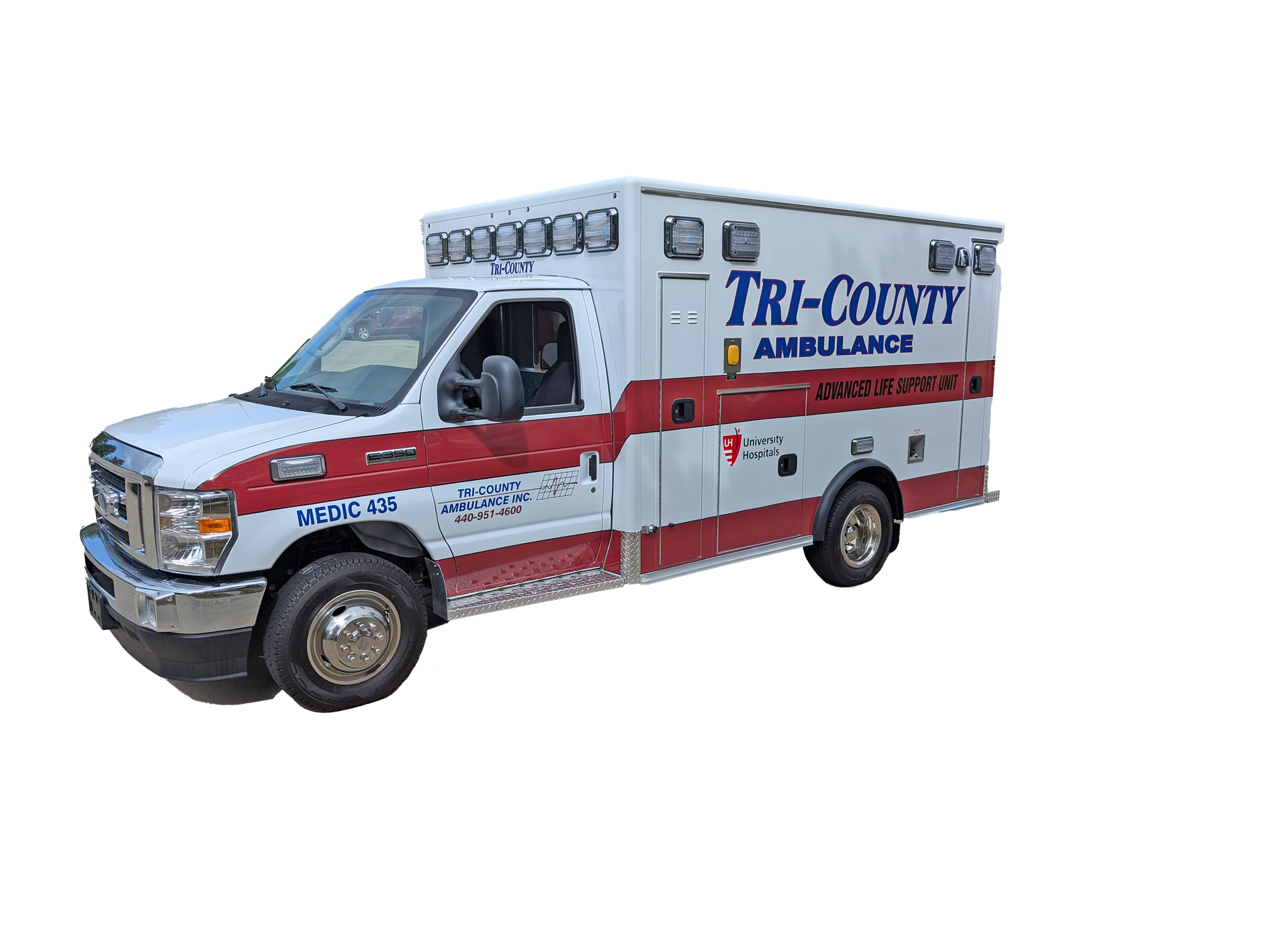 A white and red Tri-County Ambulance emergency vehicle parked against a white background.
