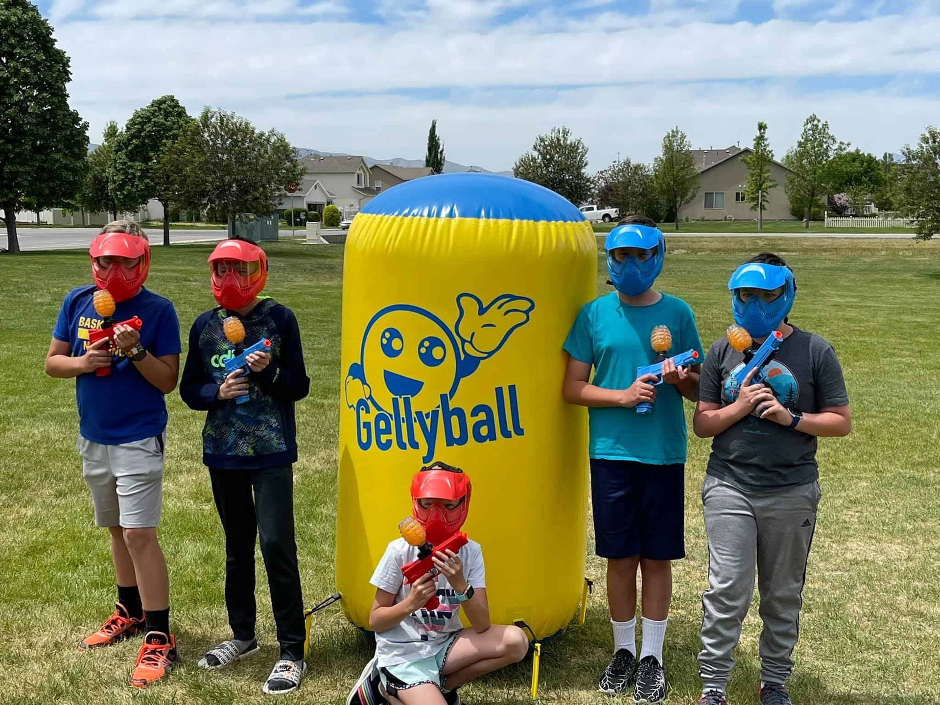 A group of children are standing in front of an inflatable gettyball.