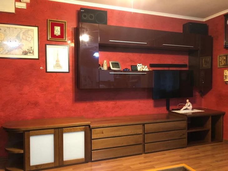 a large wooden cabinet with glass doors filled with plates and figurines