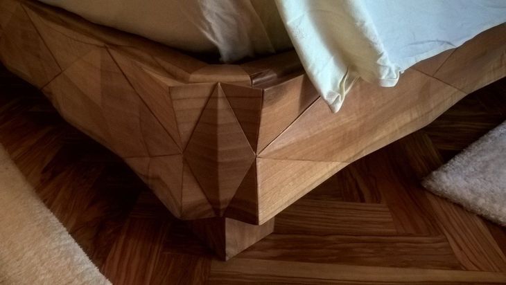 a bedroom with a large wooden wardrobe and a bed