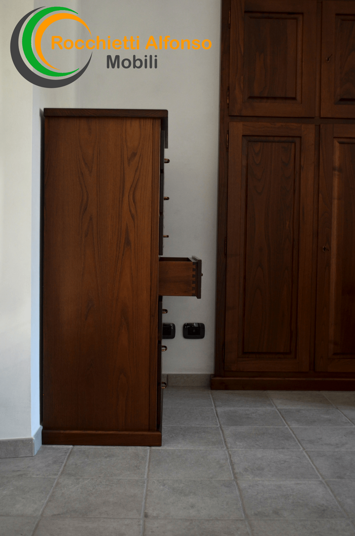 a bedroom with a large wooden wardrobe and a bed