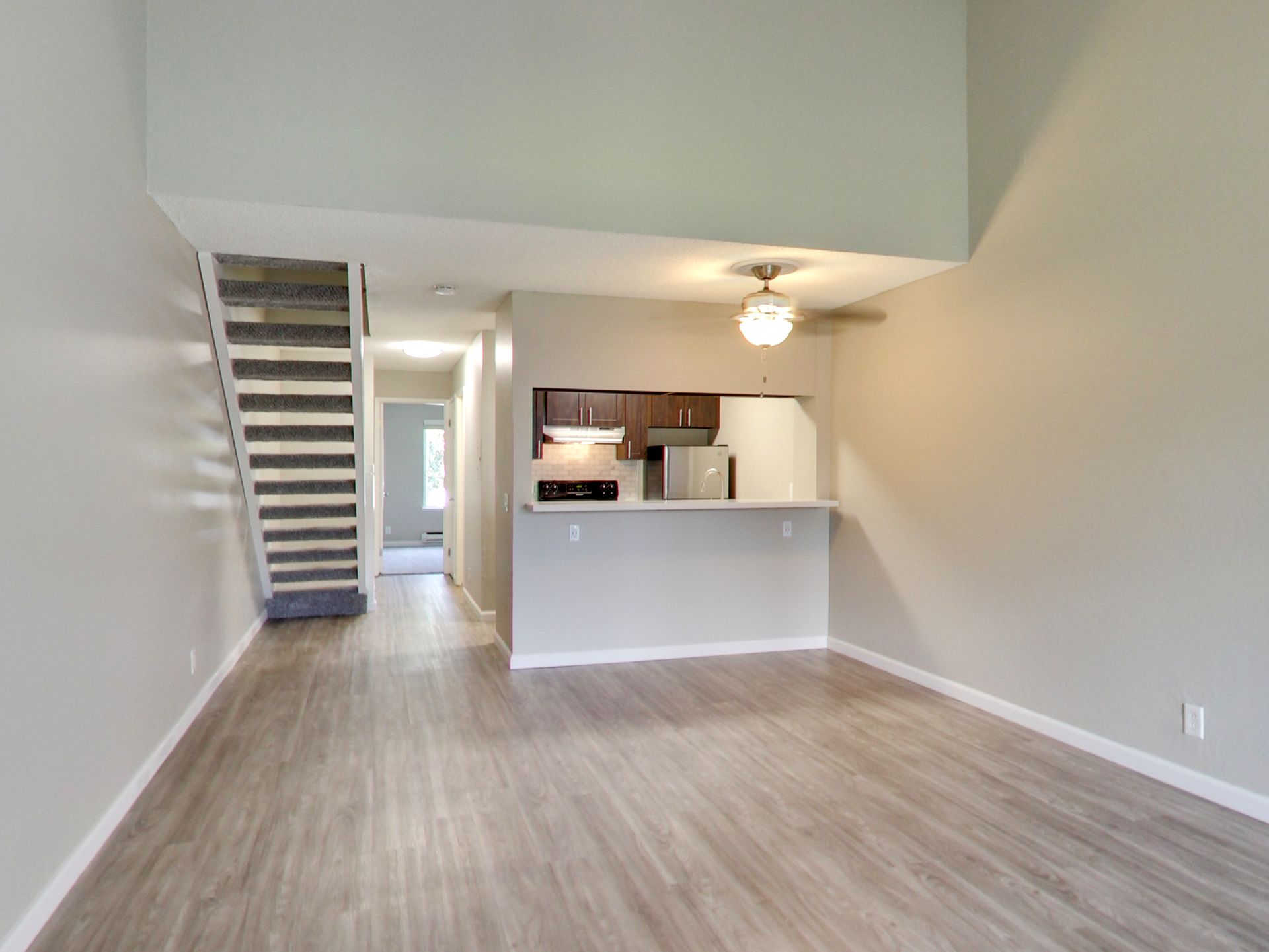 timbers apartment living room kitchen and stairs leading up to second floor
