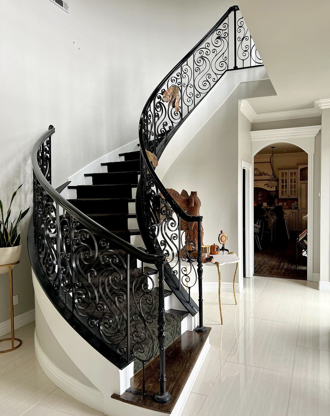 a black and white spiral staircase with a wrought iron railing