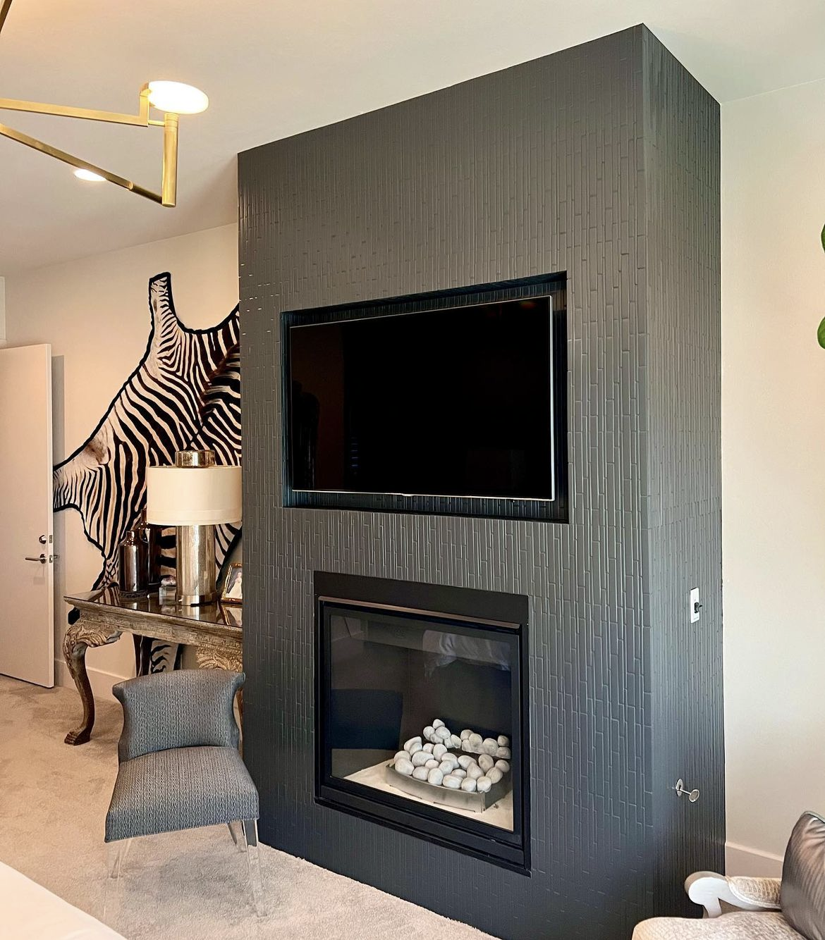 a living room with a fireplace and a flat screen tv