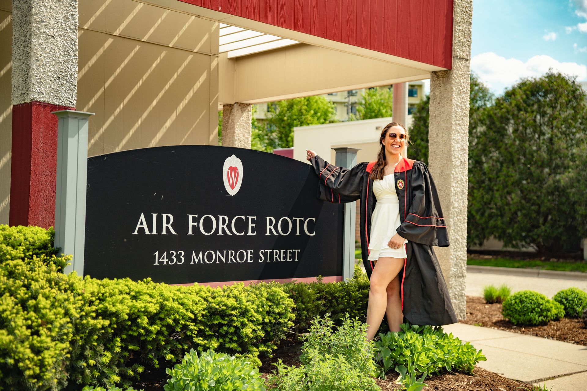 Woman posing by Air Force ROTC sign at 1433 Monroe Street