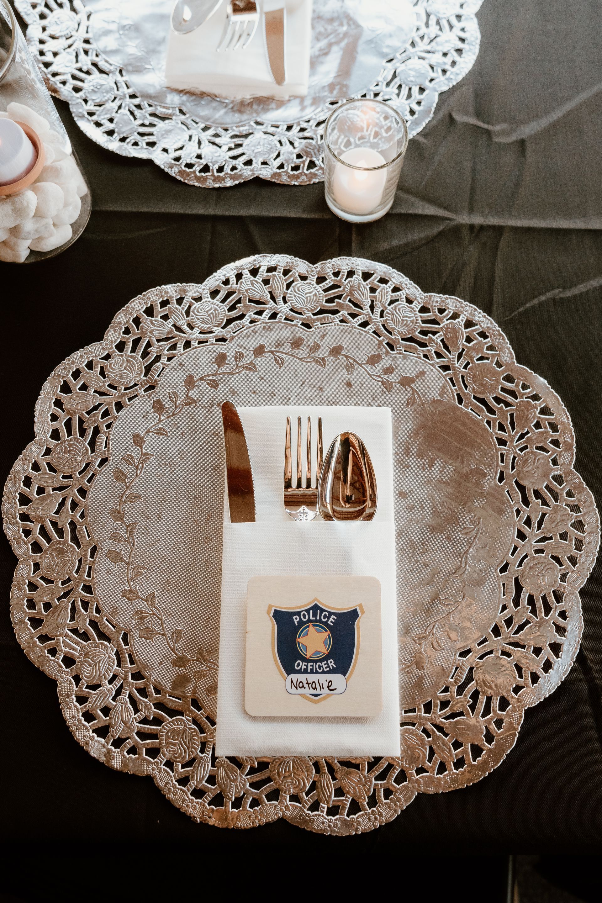 A silver plate with a napkin and utensils on it