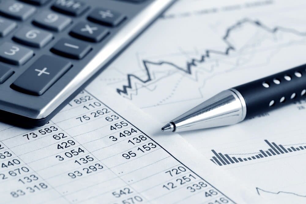 A Pen Is Sitting on A Piece of Paper Next to A Calculator — Blue Orchid Accounting In Woongarrah, NSW