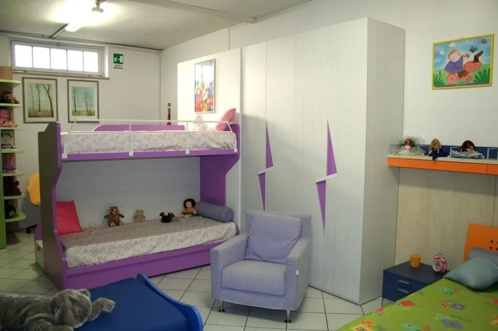 Set di mobili per la camera da letto: letto con testiera a traliccio, cassettiera con specchio, due comodini, tappeti.