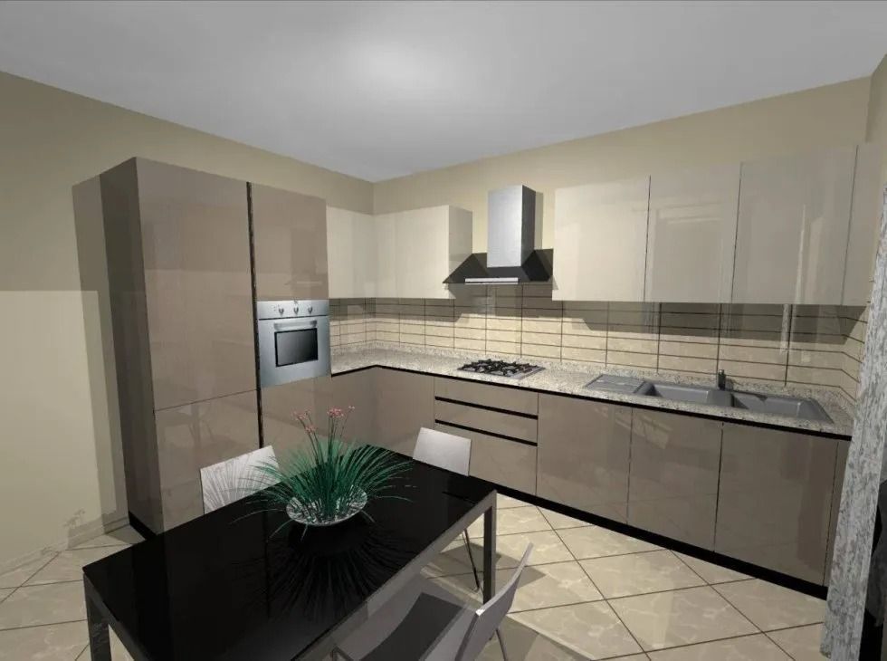 Cucina moderna con mobili color cuoio, tavolo con piano di lavoro nero e sedie da pranzo.