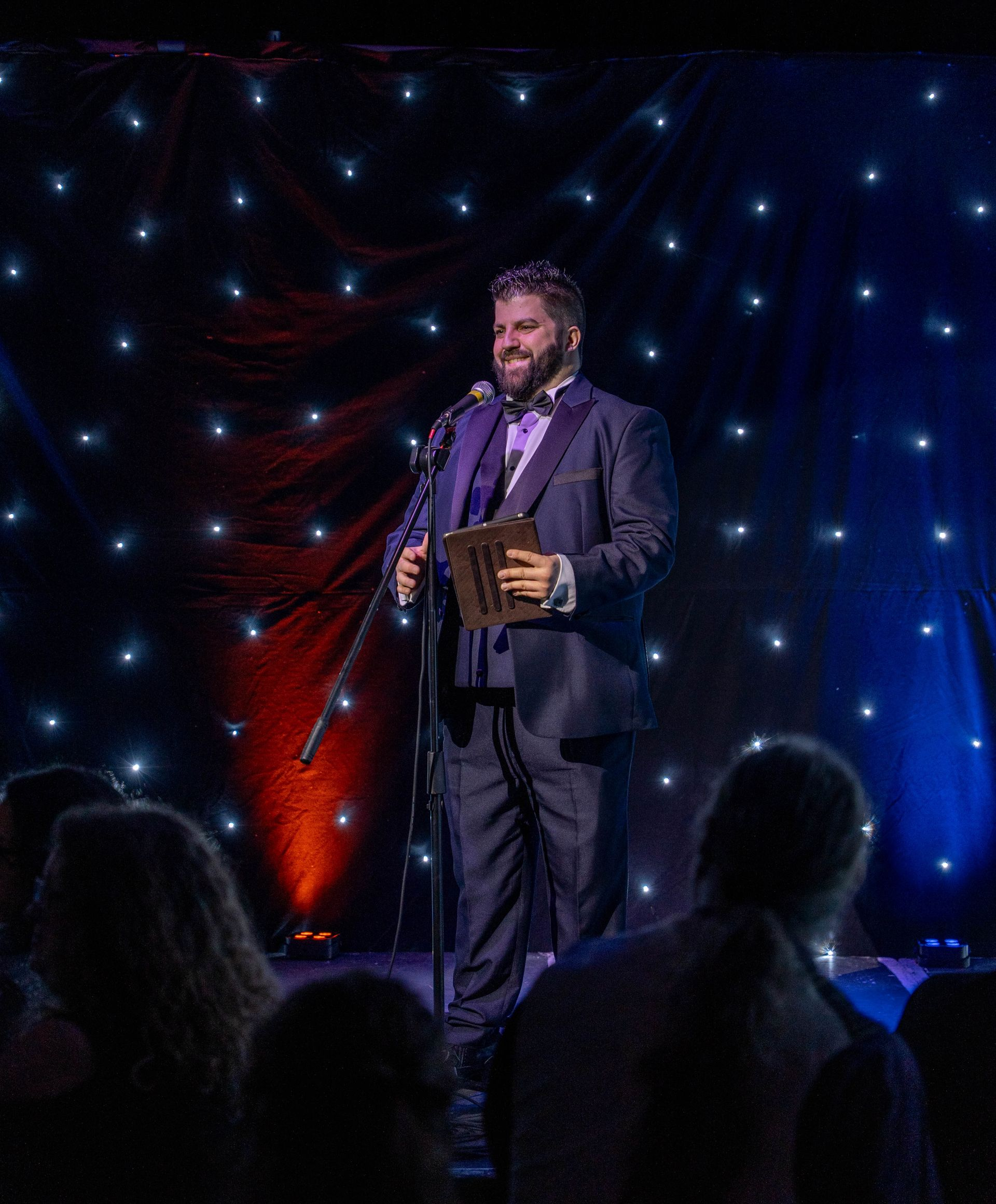 Corporate event host Daniel Chard speaking to guests at a live event