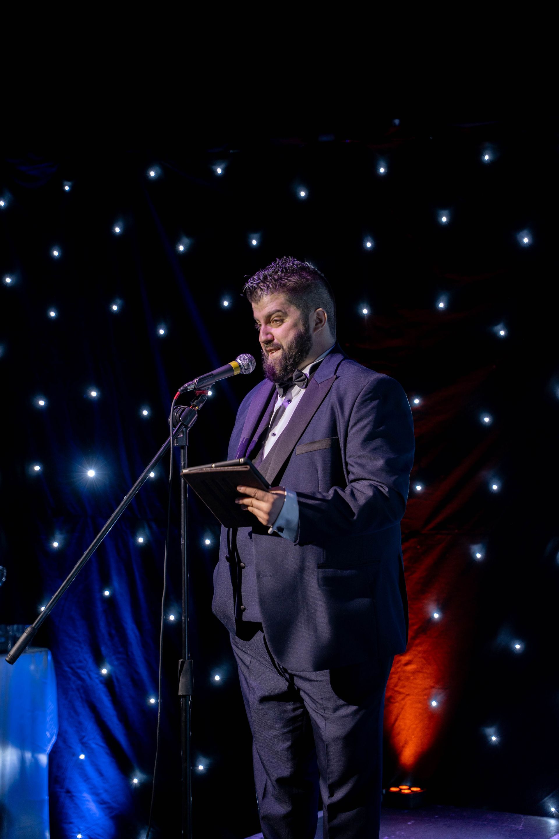 Corporate event host Daniel Chard speaking to guests at a live event