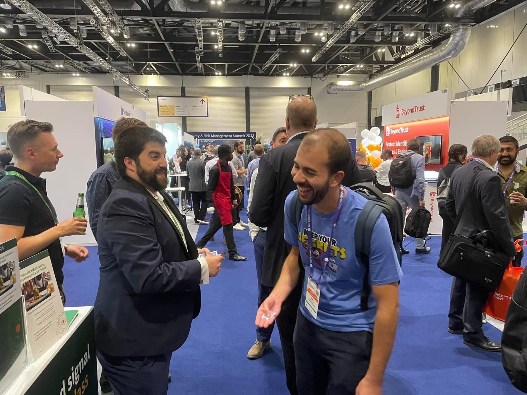 Trade show magician Daniel Chard performing interactive magic for delegates at an exhibition