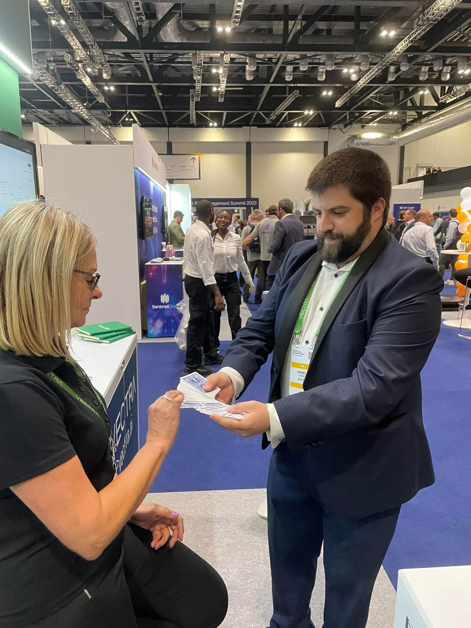 Trade show magician Daniel Chard engaging delegates during a corporate exhibition