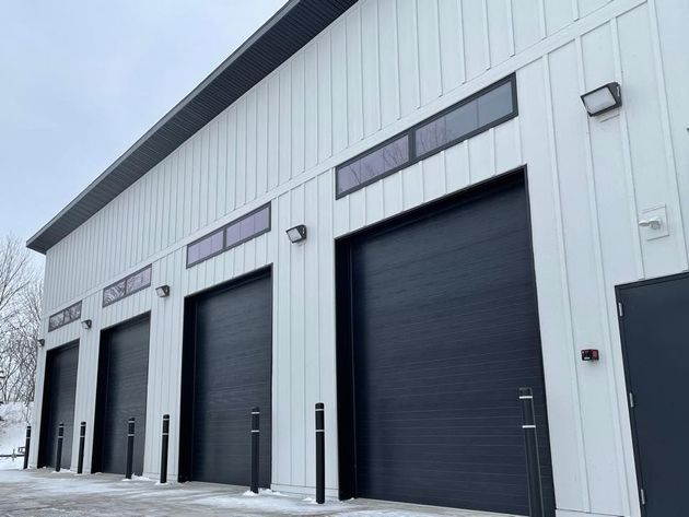 Commercial Building With Black Doors — American Overhead Door