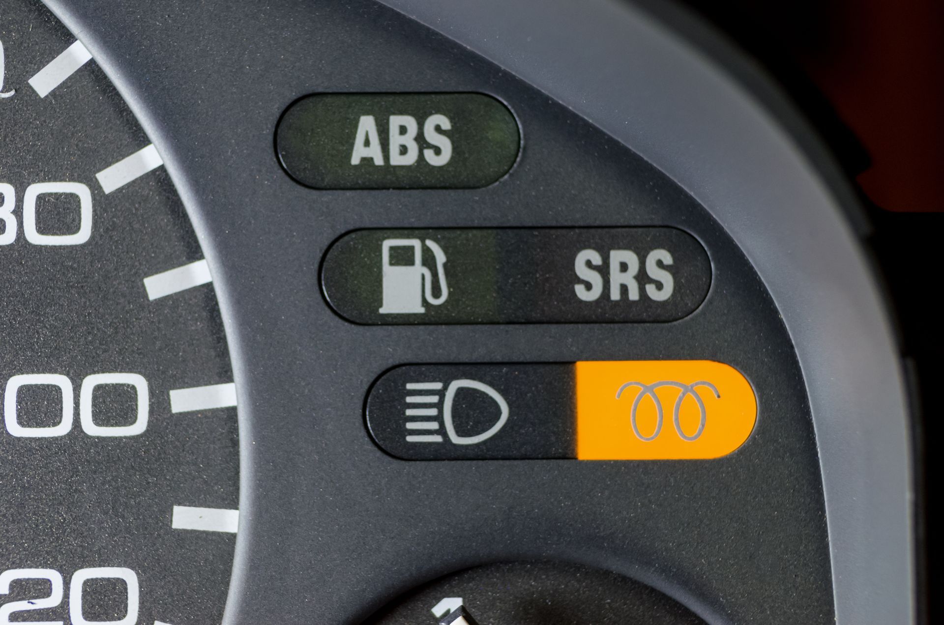 Dashboard with illuminated indicator lights: ABS, fuel, SRS, and a coil-shaped glow. | University Auto Repair