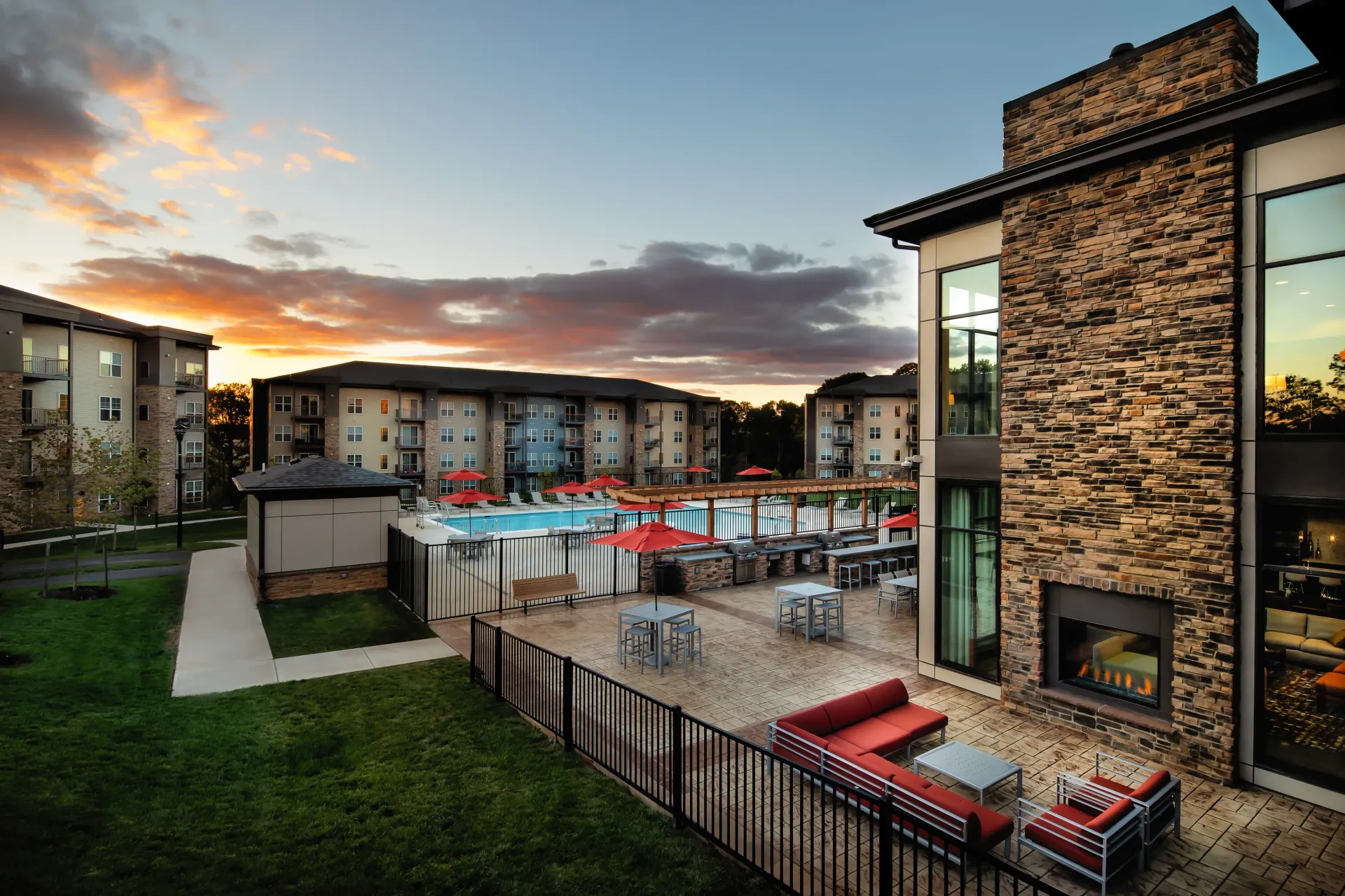 Outdoor fireplace by pool at Overlook at Franklin Square apartments in Baltimore, MD.