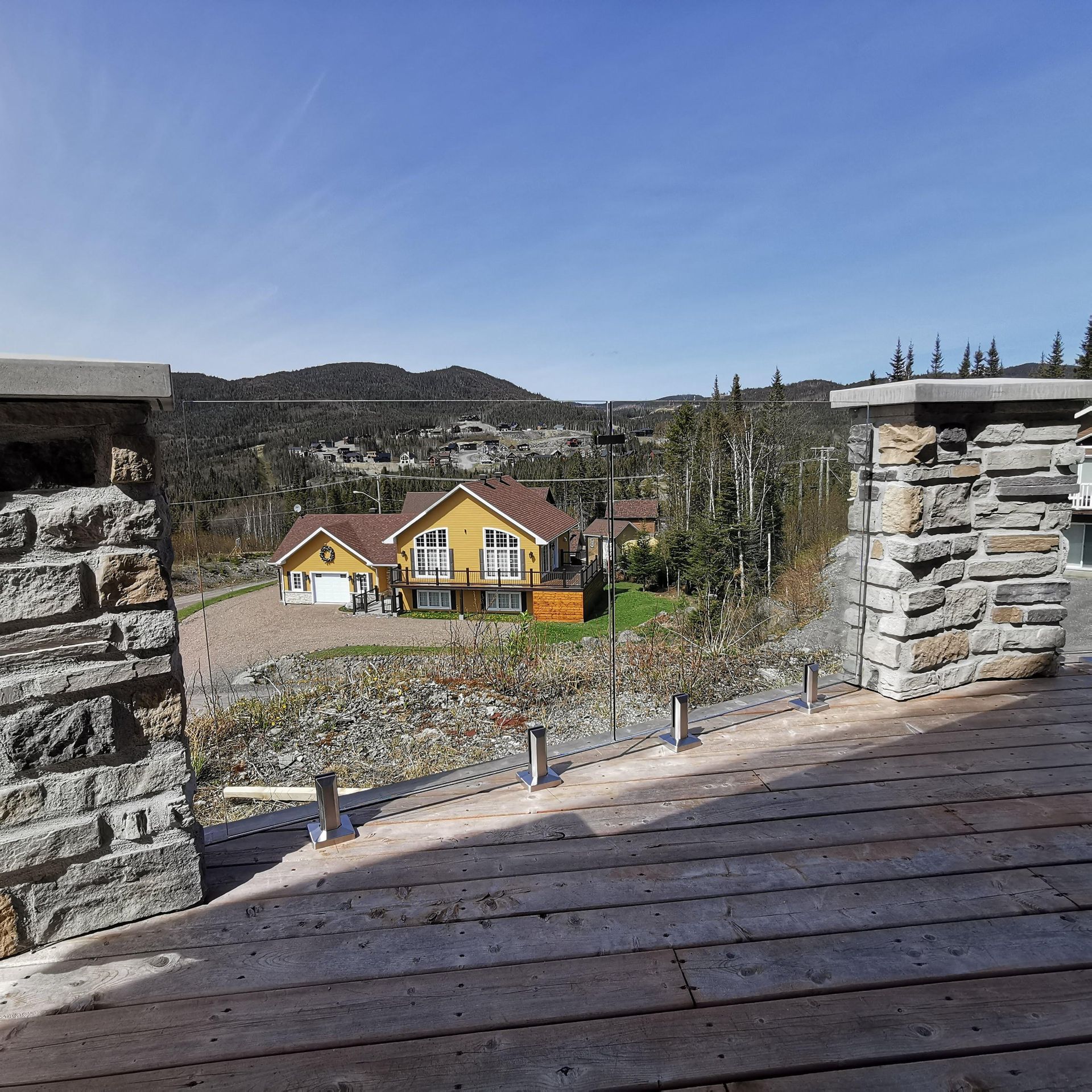 Une vue d'une maison et des montagnes depuis une terrasse