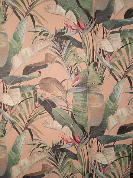 Tropical leaf wallpaper in soft pink, green, and beige tones