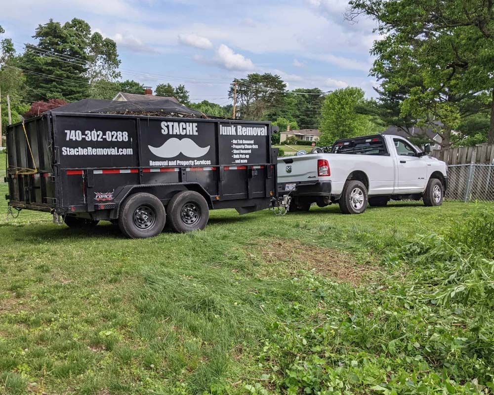Stache Junk Removal truck and trailer on property, best junk removal company near me in Lancaster and central oh
