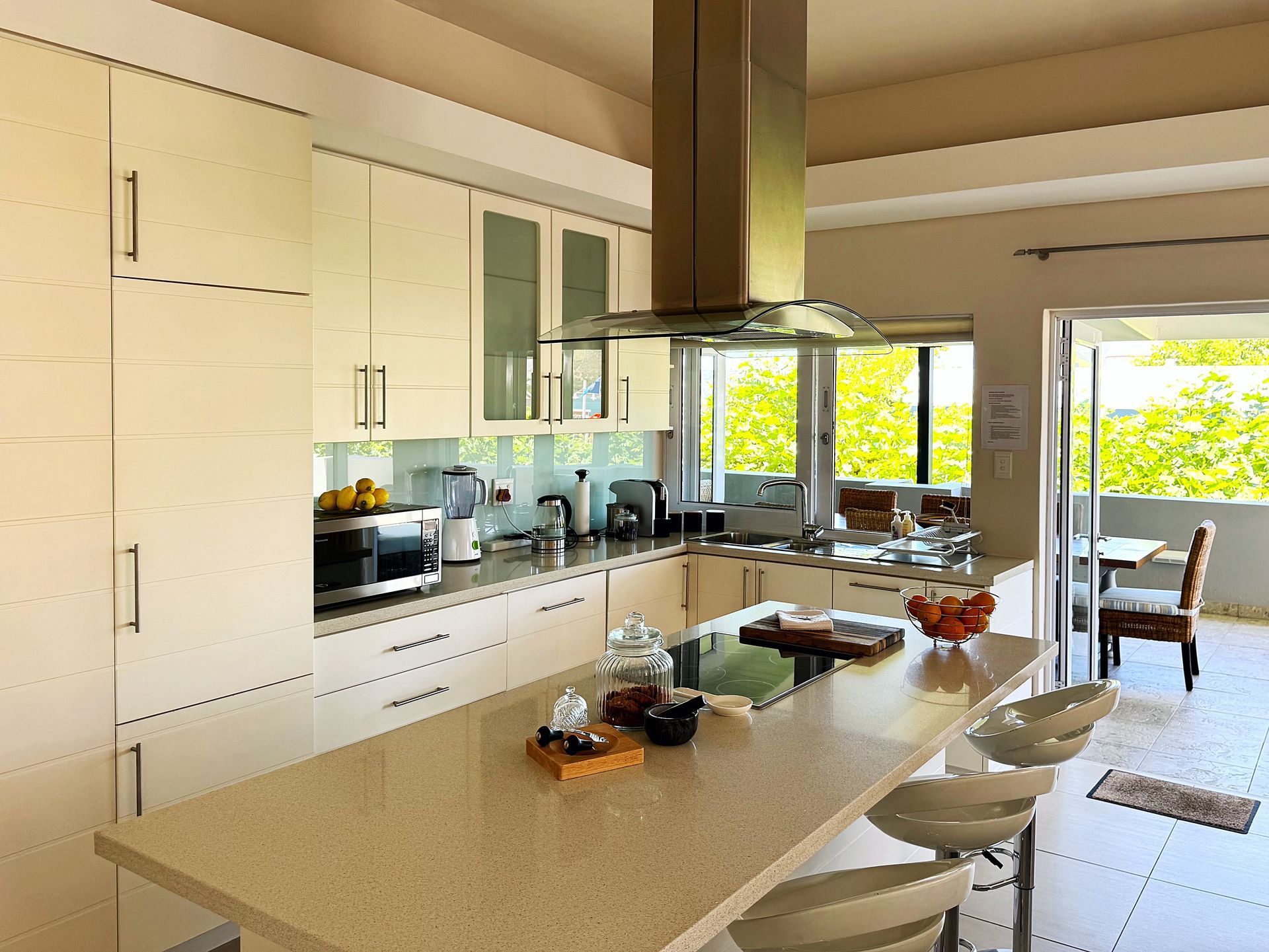 A kitchen with a large island and stools
