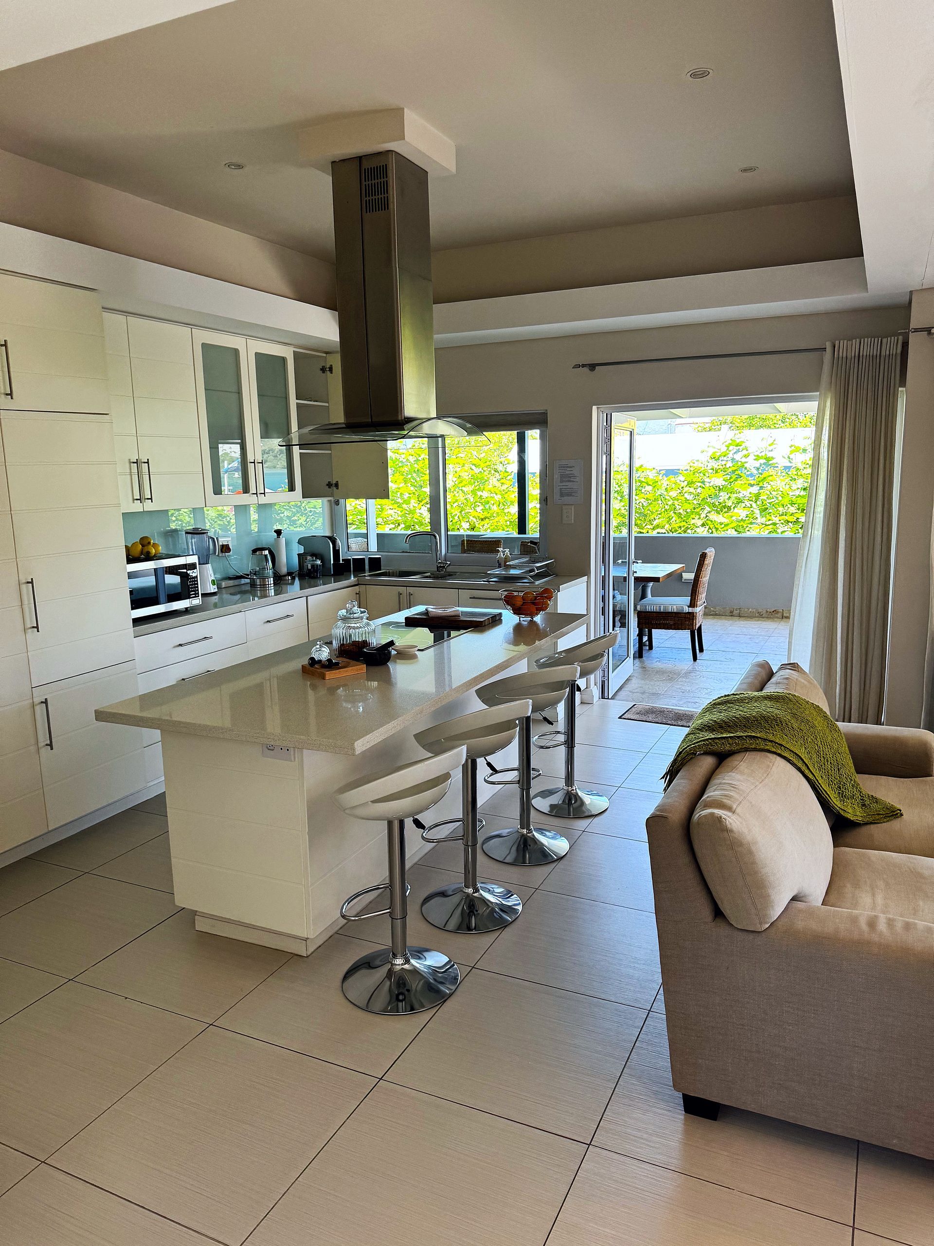 A living room with a kitchen and a couch