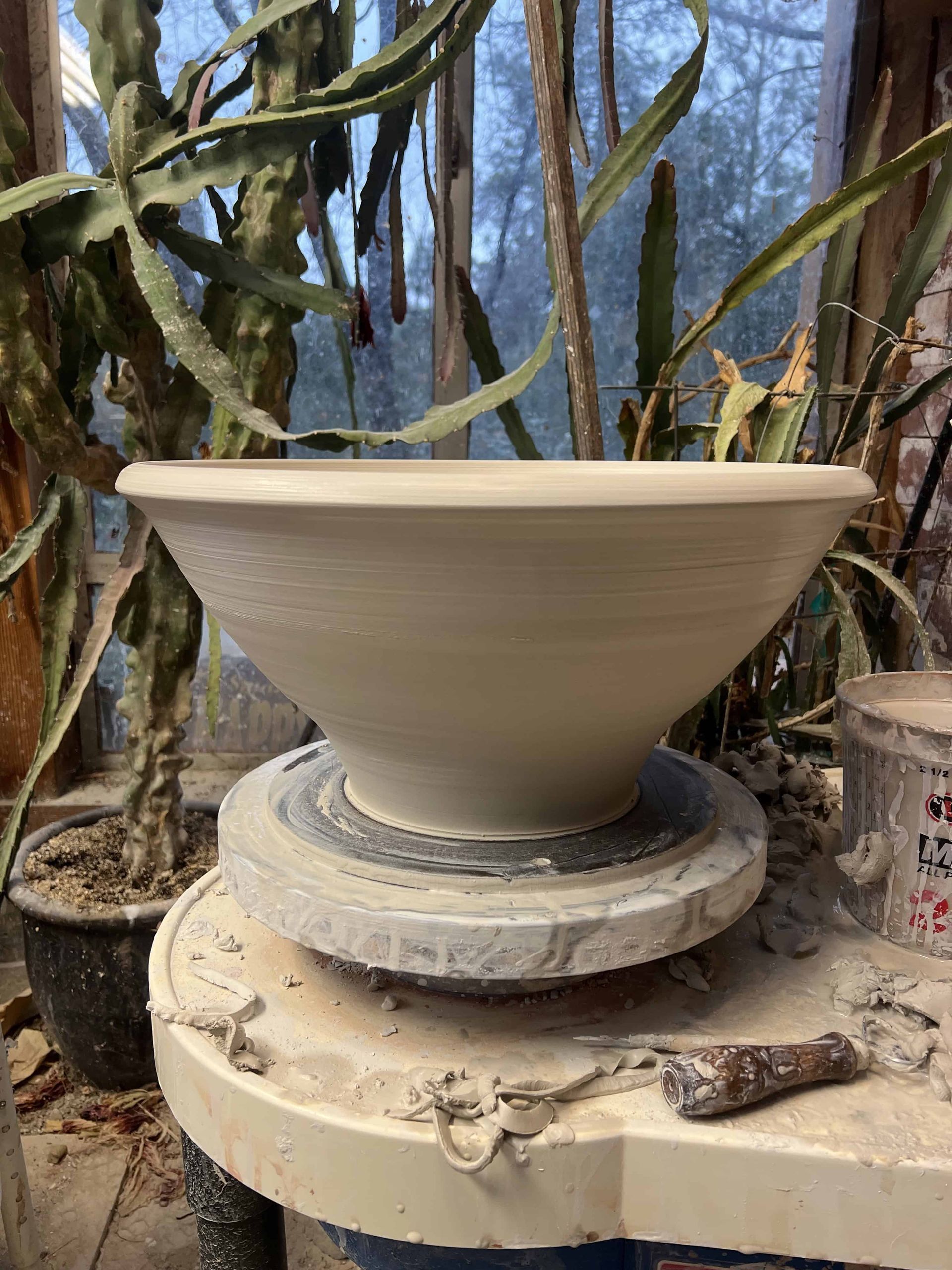 20 pound sink being thrown on on the potters wheel