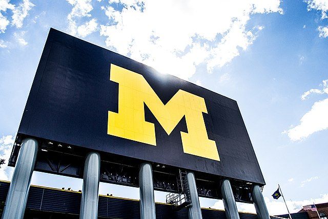 A large black and yellow sign with the letter m on it