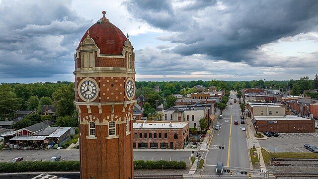 An aerial view of a clock tower in a small town.