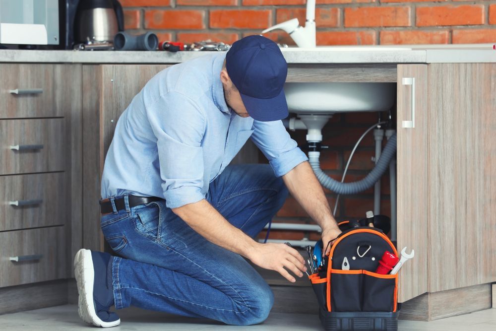 Professional Plumber Fixing Kitchen Sink — Plumbing in Wollongong