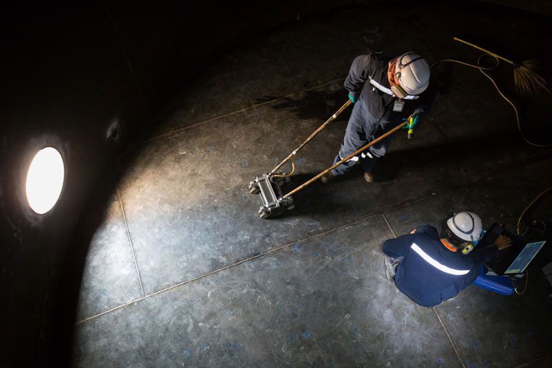 Two Workers Inspecting Tank for Rust — Commercial Plumbing in Wollongong