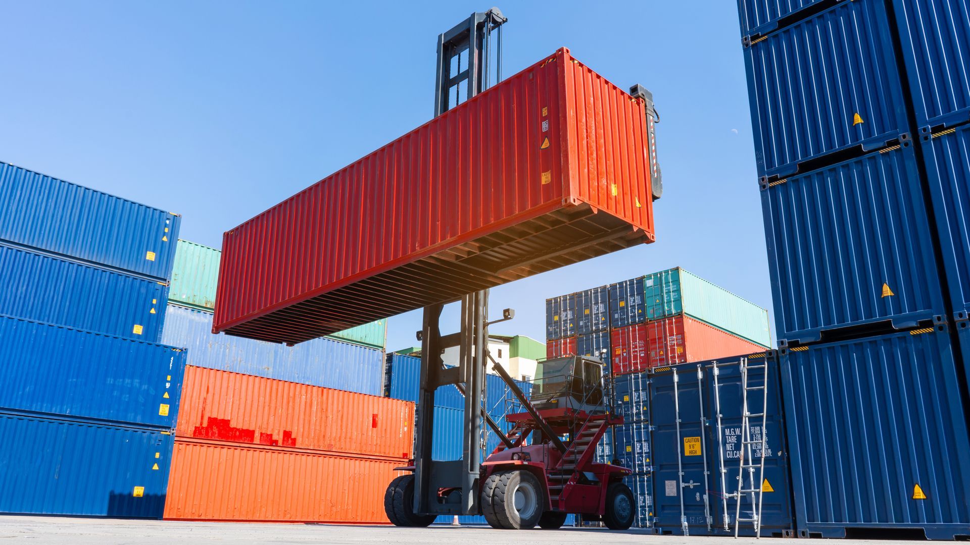Forklift working in the container cargo yard port loading cargo tank logistic service.