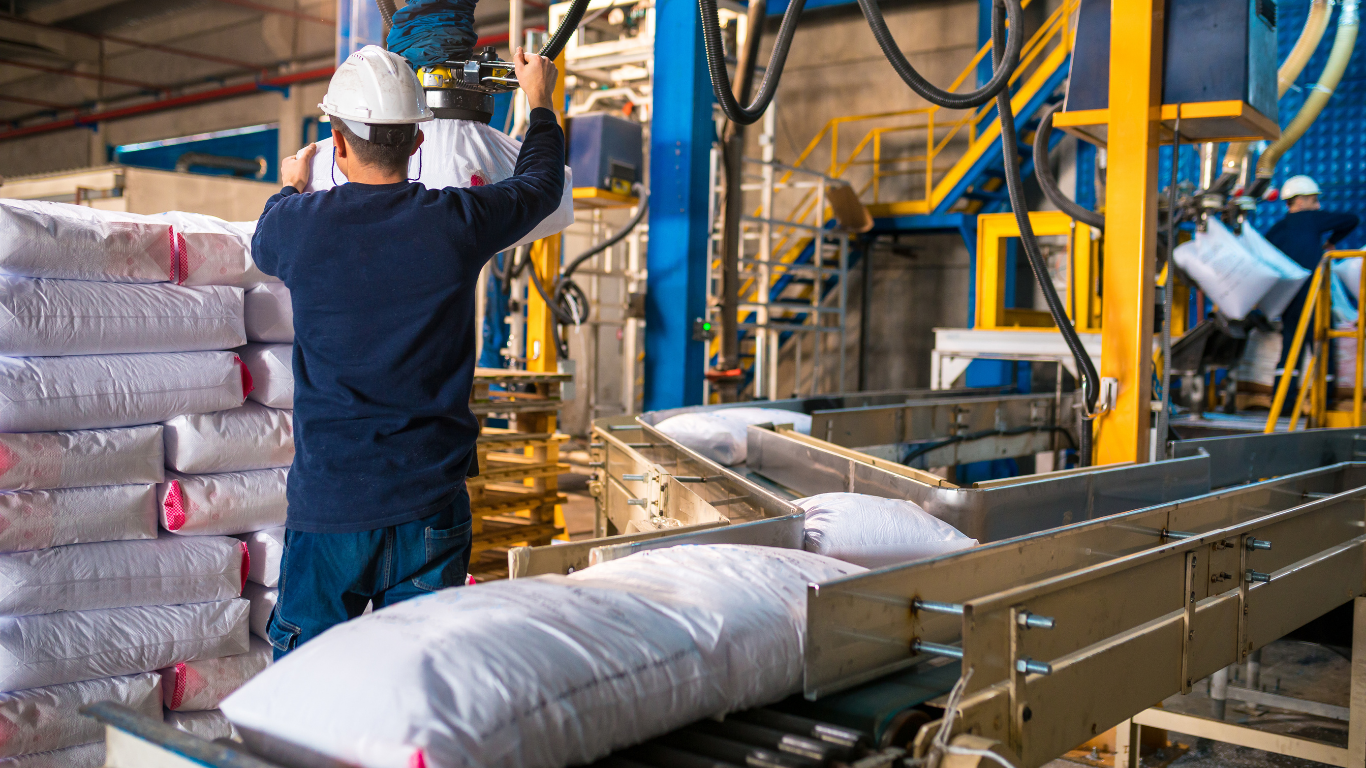 a man is working on a conveyor belt in a factory .