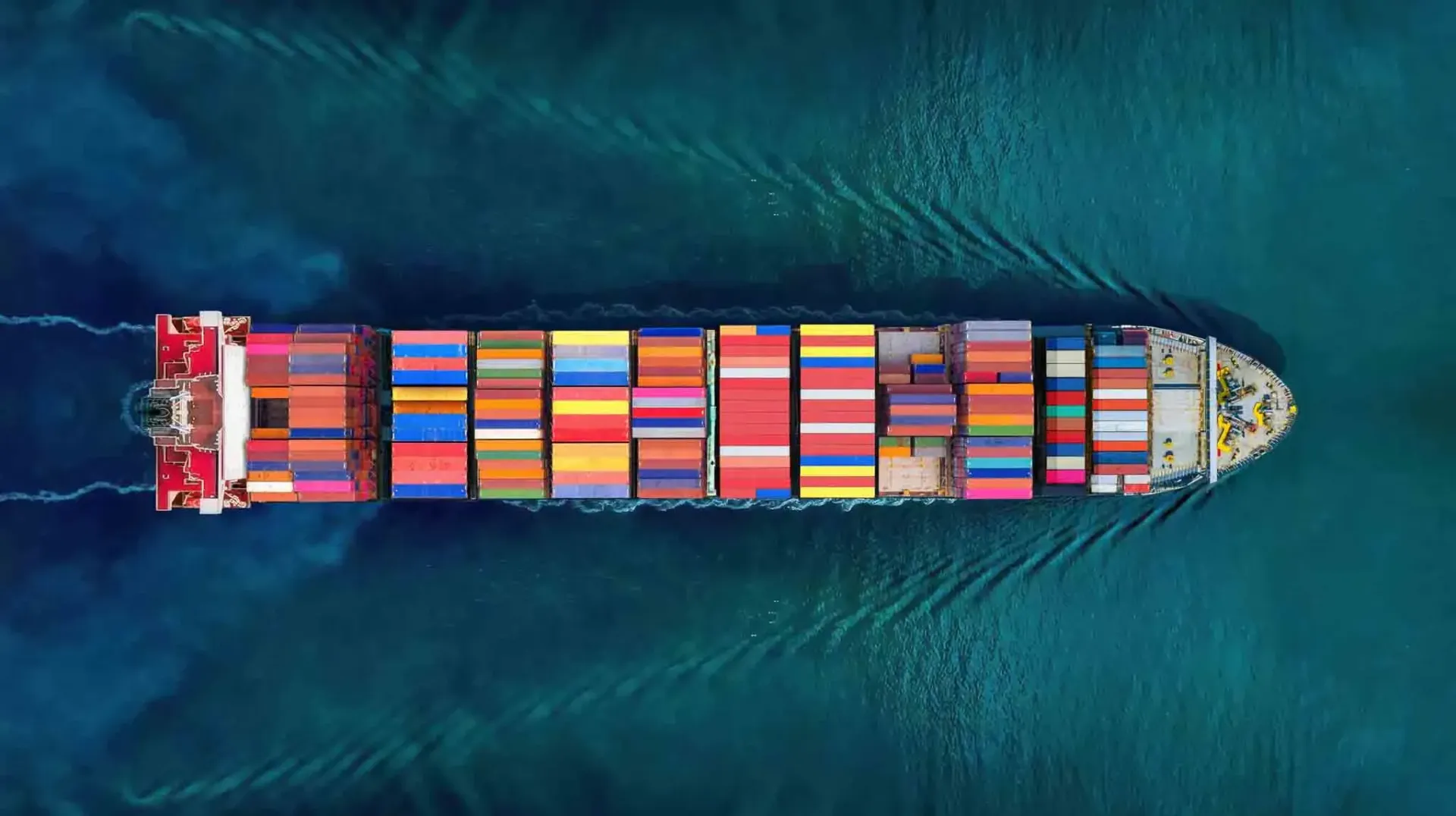 an aerial view of a large container ship floating on top of a body of water