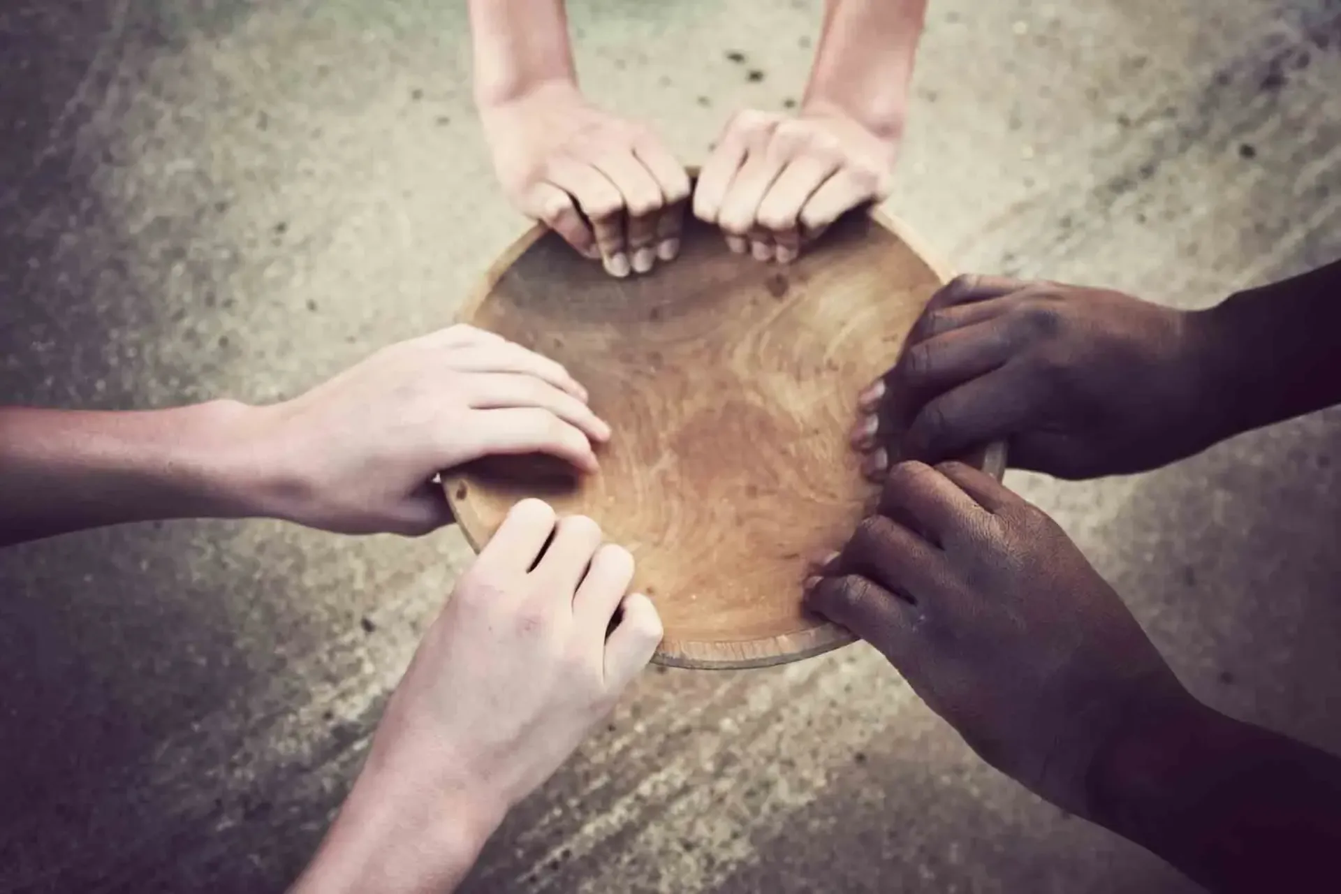 a group of people are putting their hands together in a circle