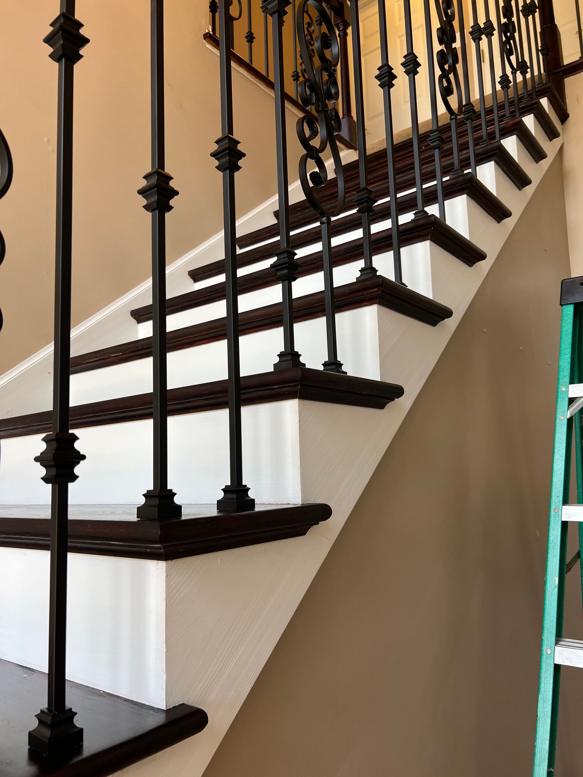 A staircase with a green ladder next to it