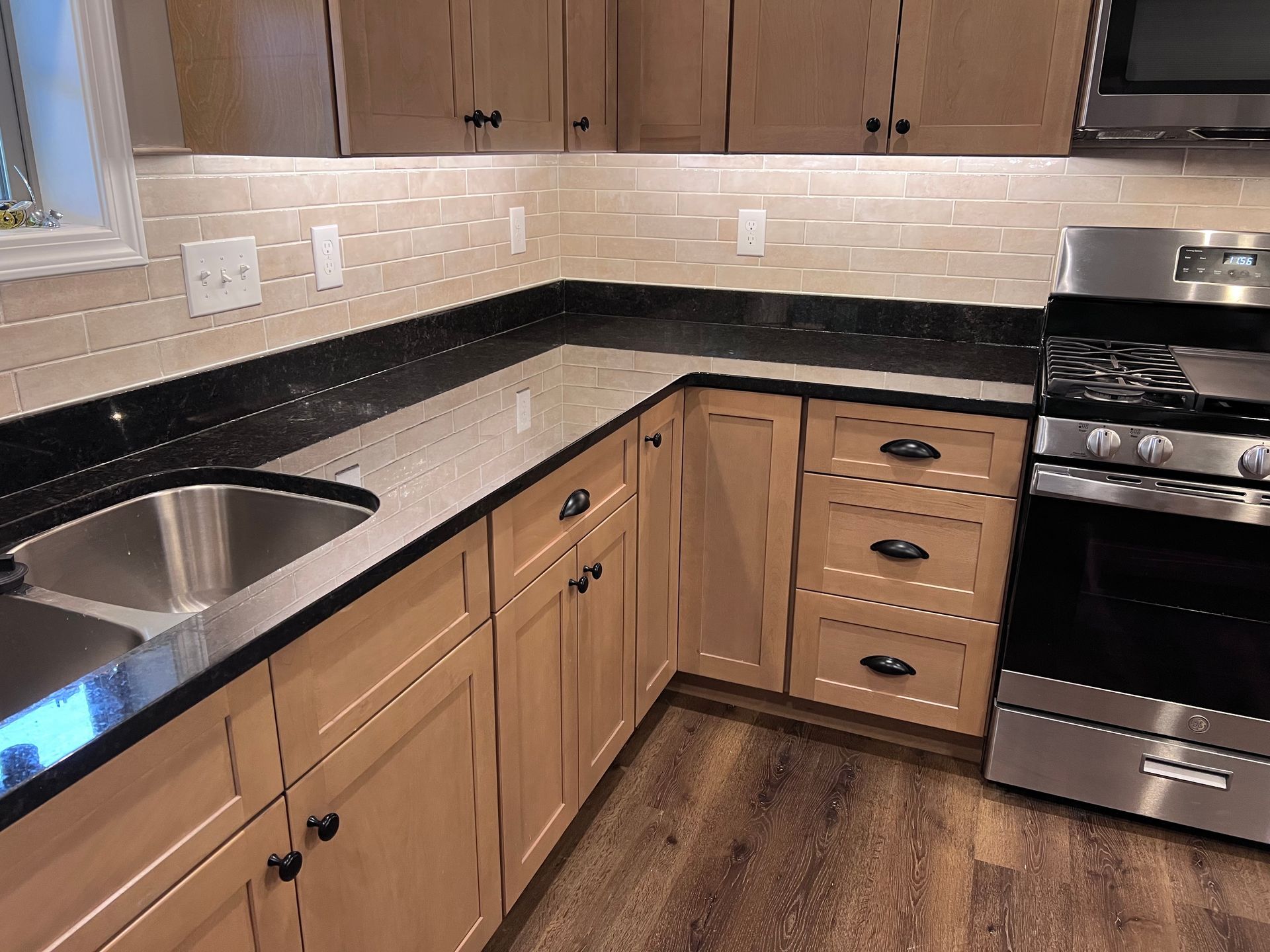A kitchen with stainless steel appliances and wooden cabinets