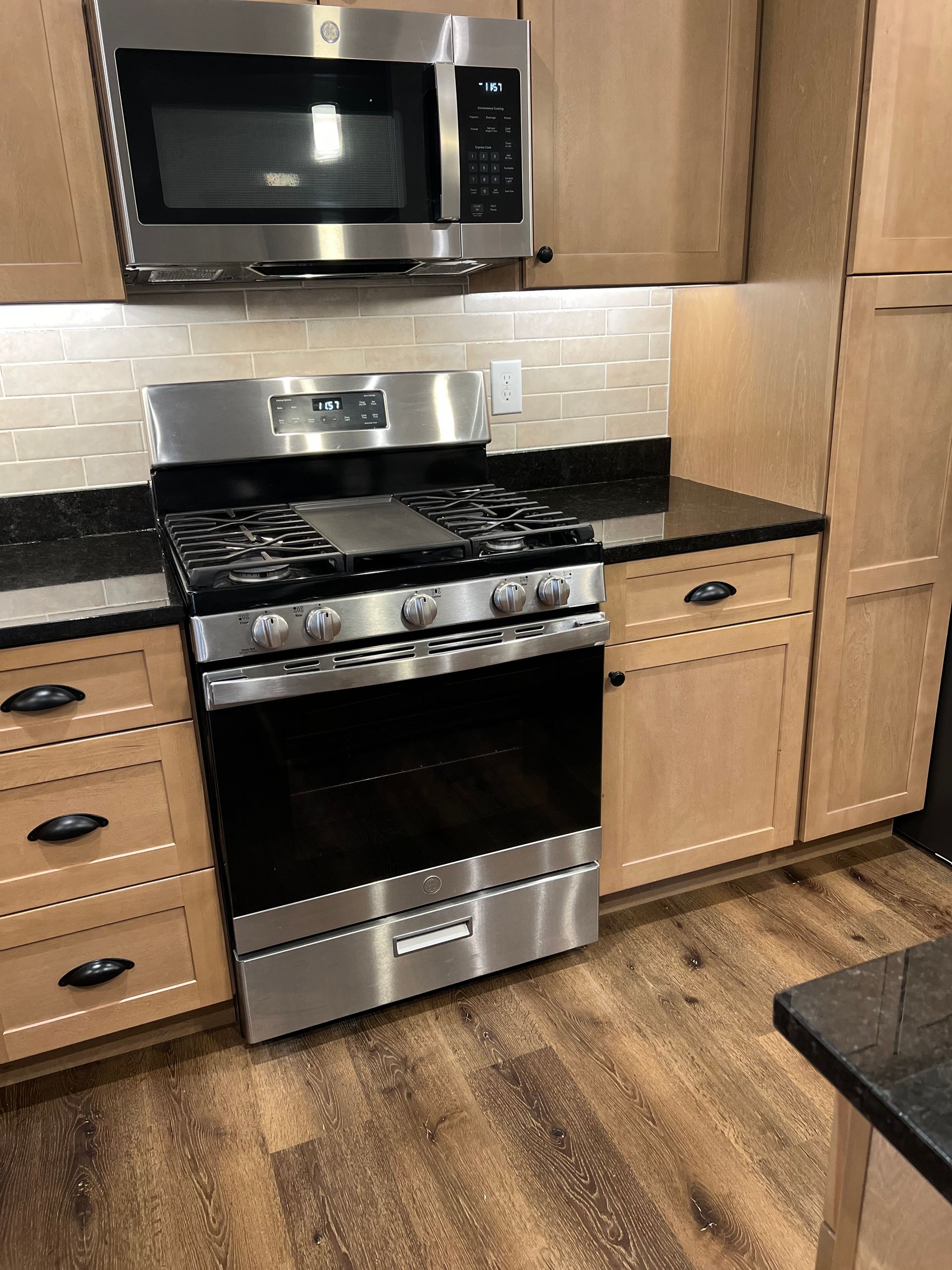 A kitchen with stainless steel appliances and wooden cabinets