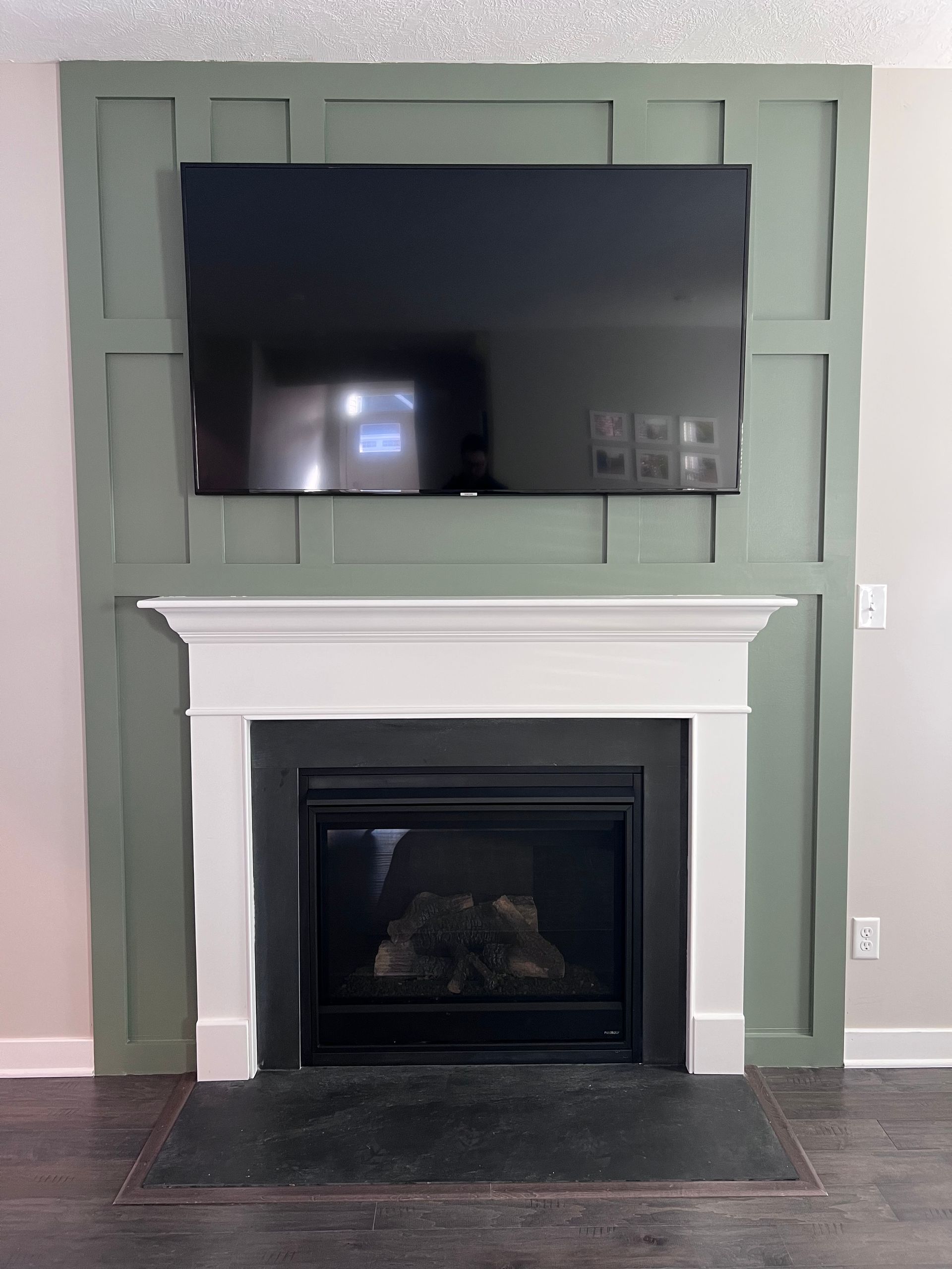 A fireplace with a flat screen tv mounted above it.