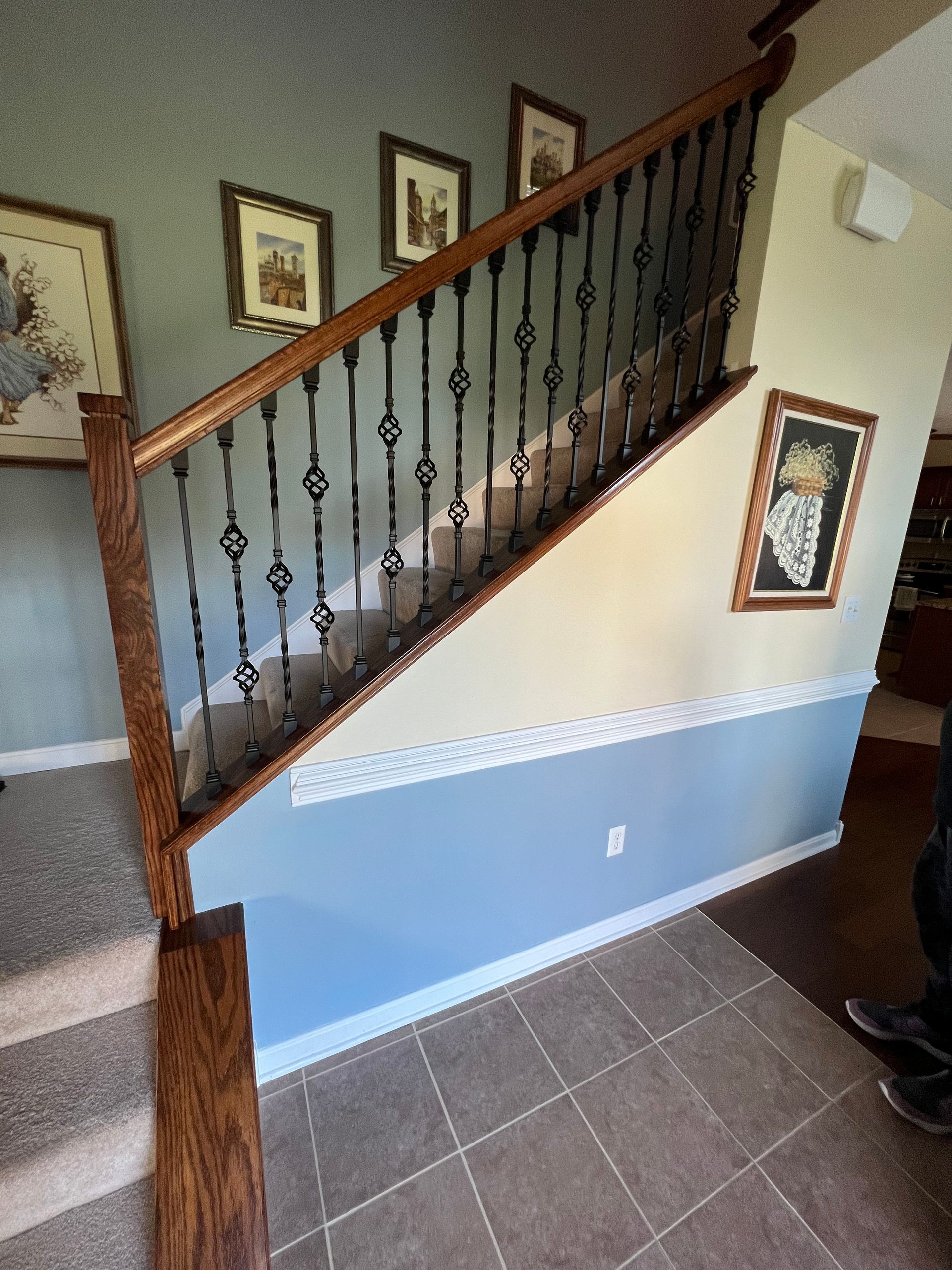 A staircase with a wrought iron railing in a house