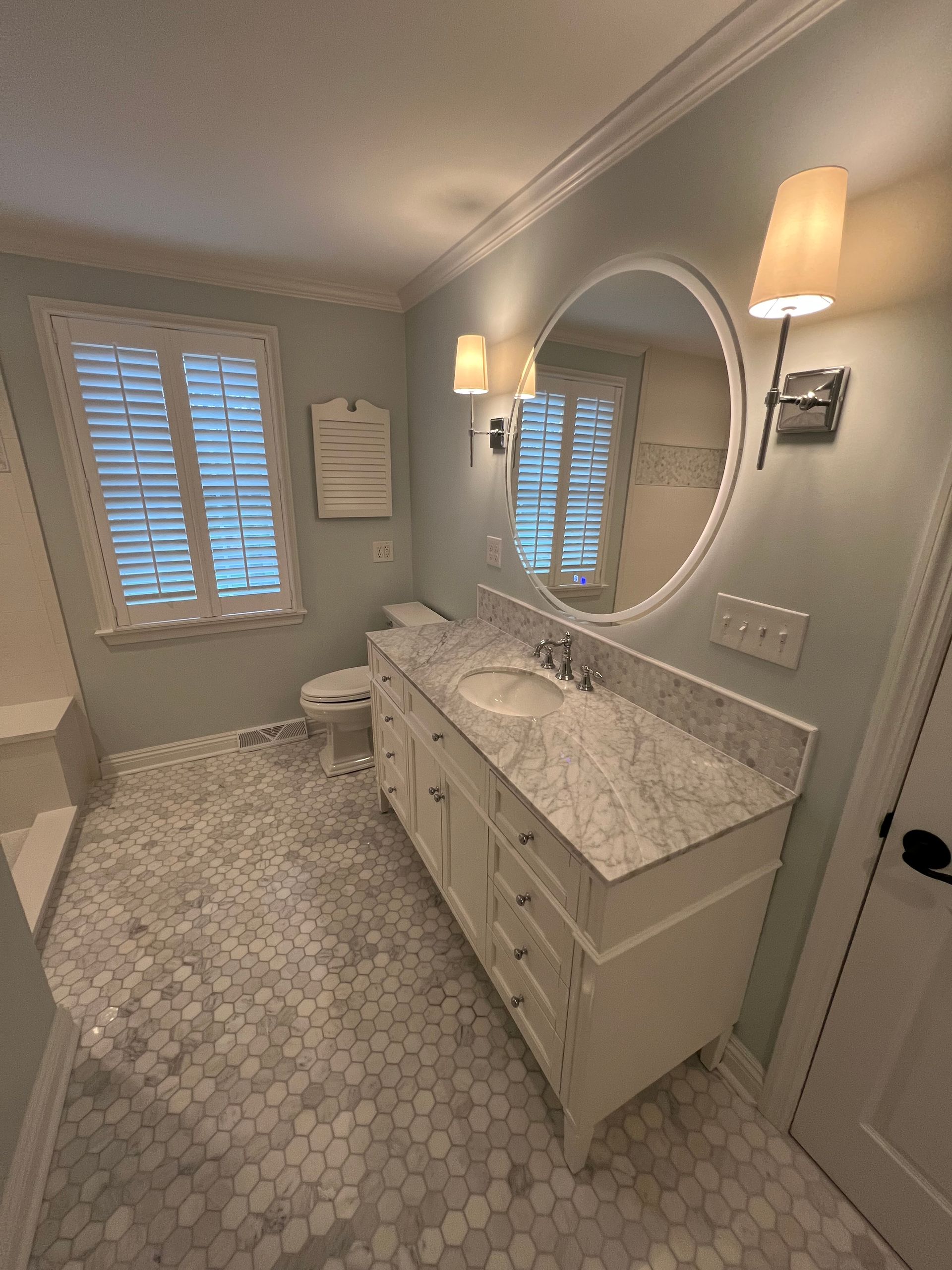 A bathroom with two sinks and a large mirror