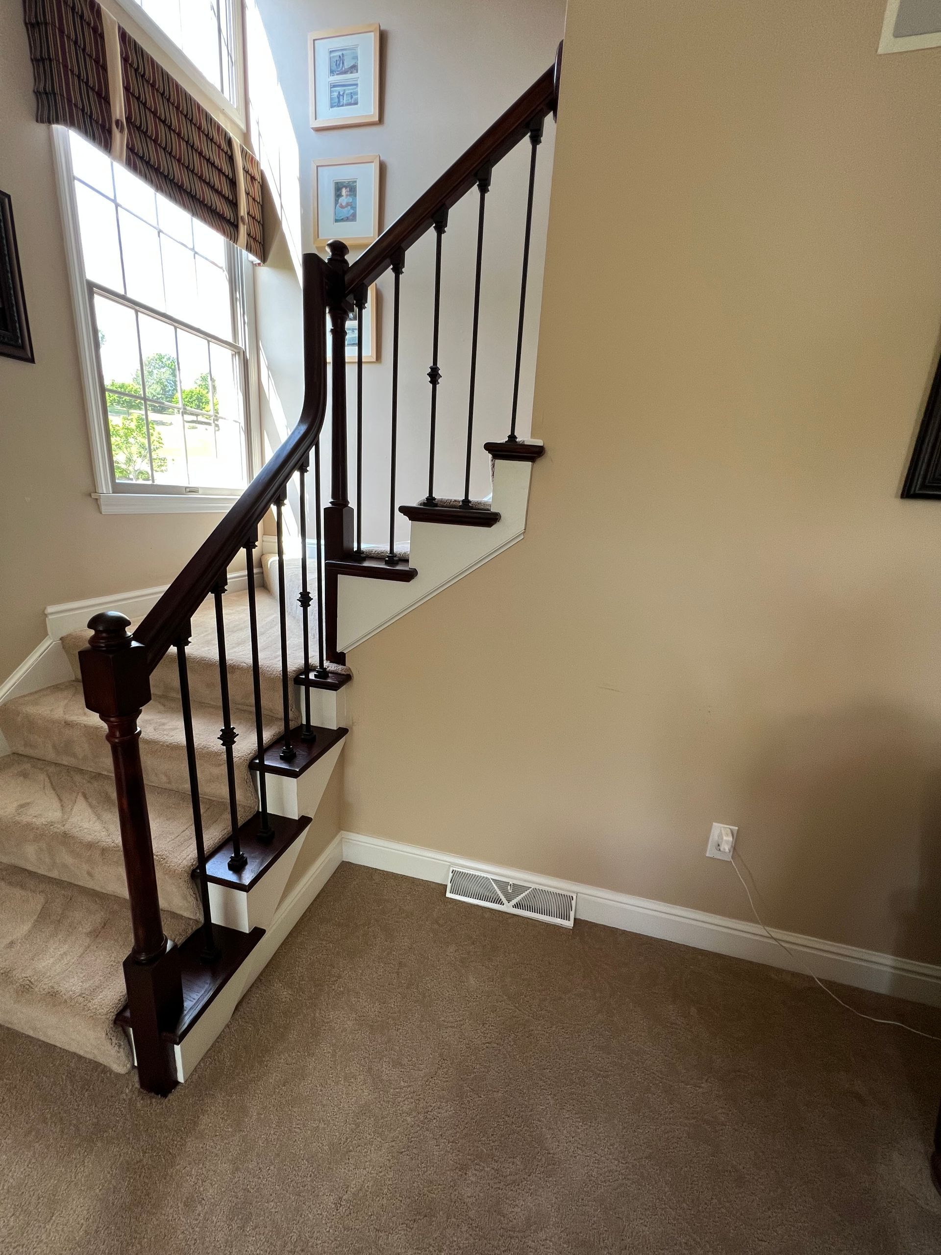 A staircase with a wooden railing in a living room
